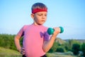 Strong Boy in an Outdoor Exercise Lifting Dumbbell Royalty Free Stock Photo