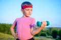 Strong Boy in an Outdoor Exercise Lifting Dumbbell Royalty Free Stock Photo