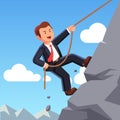 Strong business man climbing mountain with rope Royalty Free Stock Photo