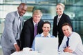 Strong business team. Group of multi ethnic business people smiling with laptop on table. Royalty Free Stock Photo