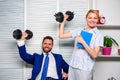 Strong business team. Healthy habits in office. Man and woman raise heavy dumbbells. Strong powerful business strategy Royalty Free Stock Photo