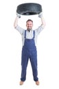 Strong cheerful engineer holding tire above head