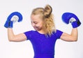 Strong child boxing. Sport and health concept. Boxing sport for female. Be strong. Girl child with blue gloves posing on