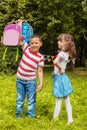 A strong child picks up two backpacks. Boy and girl Back to school. The concept of education, school, childhood Royalty Free Stock Photo