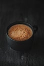 Strong coffee on a black wooden table