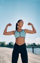 Strong and confident beautiful woman flexing her muscles Royalty Free Stock Photo