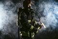 Strong fireman isolated in smoky background