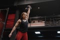 Strong crossfit woman exercising with a kettlebell at the gym. Female doing functional training