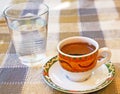 Strong Cypriot coffee with water in a glass