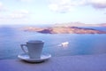 Strong delicious coffee in a white cup with a saucer against the backdrop of the sea and a floating liner. Great start to the day.