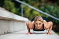 Blonde woman doing push ups outdoor. Royalty Free Stock Photo