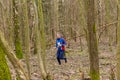 Strong elderly caucasian man wearing sportswear running through a forest