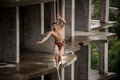 Strong fearless topless man balancing on a slackline on rainy day