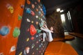 Strong female climber on boulder climbing wall indoor Royalty Free Stock Photo