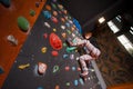 Strong female climber on boulder climbing wall indoor Royalty Free Stock Photo