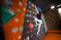 Strong female climber on boulder climbing wall indoor Royalty Free Stock Photo