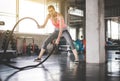 Strong woman using battle rope at gym,Female doing exercise in functional training Royalty Free Stock Photo