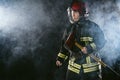 Strong fireman isolated in smoky background