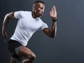 A strong and fit African-American man running or sprinting. Royalty Free Stock Photo