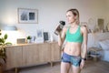 Woman drinking water after doing fitness exercises at home Royalty Free Stock Photo