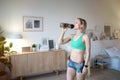 Woman drinking water after doing fitness exercises at home Royalty Free Stock Photo