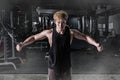 Strong fitness man doing arm workout with cable machine in the gym Royalty Free Stock Photo