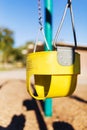 Yellow toddler`s playground swing with strong Depth-of-field