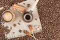 Strong coffee with foam, cinnamon, sugar stick, nutmeg on the bu Royalty Free Stock Photo