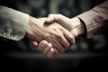 Strong friendly partnership business handshake of two male hands, dark background isolate.