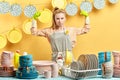 Strong frowning woman with raised arms is ready to wash the dishes after party