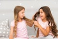 Strong hair. Children cheerful play with hair in bedroom. Happy childhood moments. Kids girls sisters best friends full