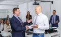 Strong handshake of two ordinary businessmen Royalty Free Stock Photo