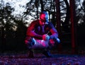 Strong handsome and muscular squatting slav taking a break from hard street workout, man in squatting position Royalty Free Stock Photo