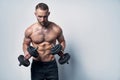 Strong sport sirtless man making weightlifting with dumbbells