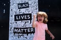 Strong happy child and Black lives matter poster.