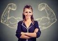 Strong happy young woman on gray background