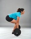 Strong hispanic woman doing deadlift Royalty Free Stock Photo