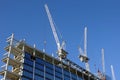 Strong hoisting tower crane on the top section being construction of modern high skyscraper building