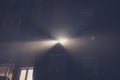 Strong light from an appartment window is pearcing out into thick fog outside. Beam of light from apartment Royalty Free Stock Photo