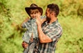 Strong like father. Power being father. Child having fun cowboy dad. Rustic family. Growing cute cowboy. Small helper in Royalty Free Stock Photo