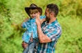 Strong like father. Power being father. Child having fun cowboy dad. Rustic family. Growing cute cowboy. Small helper in Royalty Free Stock Photo