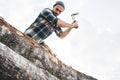 Strong logger worker cuts tree in forest Royalty Free Stock Photo