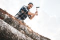 Strong lumberjack in plaid shirt chops tree in wood with sharp ax, close up axe, wood chips fly