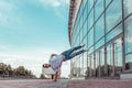 Strong man acrobat dancer, handstand, breakdance dancing, summer city, free space text, hip hop dancer. Youth lifestyle Royalty Free Stock Photo