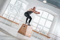 Strong man doing jumping exercises over box at a cross training style gym Royalty Free Stock Photo