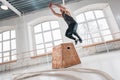 Strong man doing jumping exercises over box at a cross training style gym Royalty Free Stock Photo