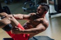 Strong man in the gym doing abs exercises Royalty Free Stock Photo