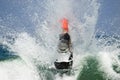 Strong man jumps on the jet ski above the water Royalty Free Stock Photo