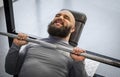 Strong man lifting weight in the gym, male athlete training at fitness club Royalty Free Stock Photo