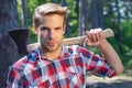 Strong man. Lumberjack on serious face carries axe on shoulder. Sexy guy. Royalty Free Stock Photo